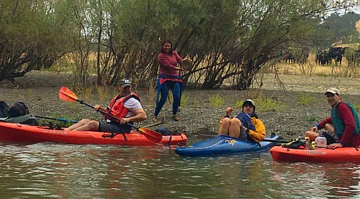 The reason for the barbed wire fence crossing the river: a small herd of cows that had no water source except for the River. Meghan stands holding one of hundreds of “cow pies” that lined the beach next to the water. Manure is a major source of fecal coliform bacteria, as well as nitrogen and phosphate that make algae grow.