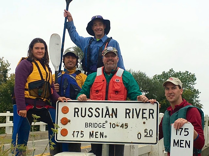 Paddlers posing by Highway 175 bridge sign where they started the day’s journey in Hopland on the way to Cloverdale through the roughest section of the River. Meghan Walla-Murphy (trip organizer with Landpaths), Craig Anderson (Director of Landpaths), James Gore (Sonoma Co 4th District Supervisor), Bert Whittaker (Park Operations Manager with Sonoma County Regional Parks) and up top your Riverkeeper Don McEnhill.